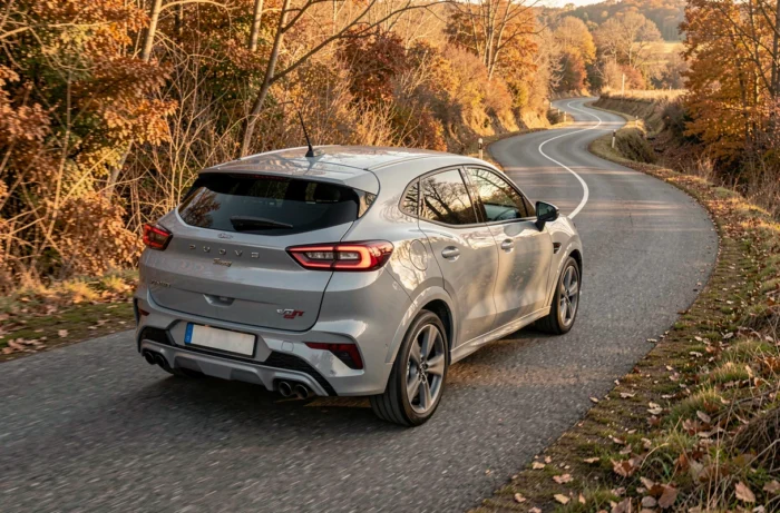 Ford Puma gris Solar ST-Line vue arrière trois quarts sur route de campagne entourée de feuillages automnaux